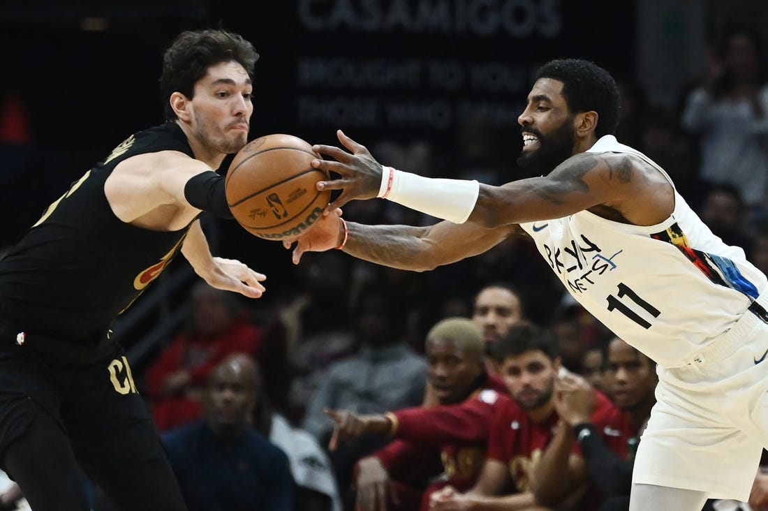 Dec 26, 2022; Cleveland, Ohio, USA; Cleveland Cavaliers forward Cedi Osman (16) and Brooklyn Nets guard Kyrie Irving (11) go for a loose ball during the second half at Rocket Mortgage FieldHouse. Mandatory Credit: Ken Blaze-USA TODAY Sports