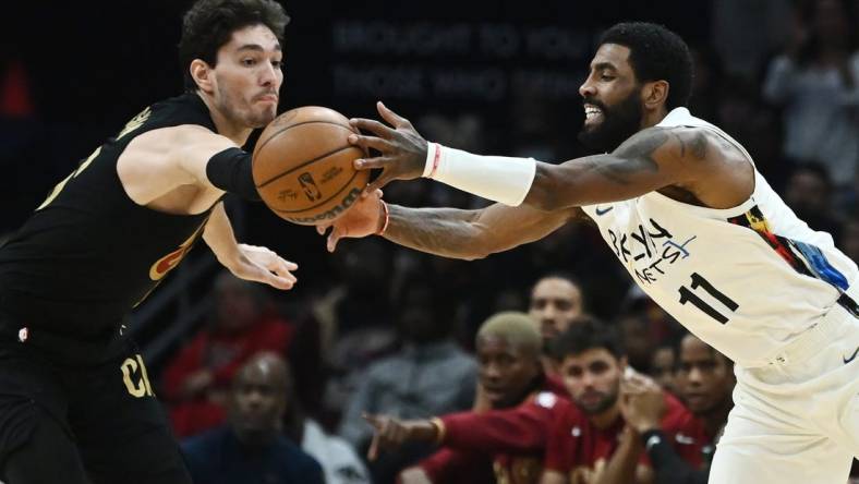 Dec 26, 2022; Cleveland, Ohio, USA; Cleveland Cavaliers forward Cedi Osman (16) and Brooklyn Nets guard Kyrie Irving (11) go for a loose ball during the second half at Rocket Mortgage FieldHouse. Mandatory Credit: Ken Blaze-USA TODAY Sports