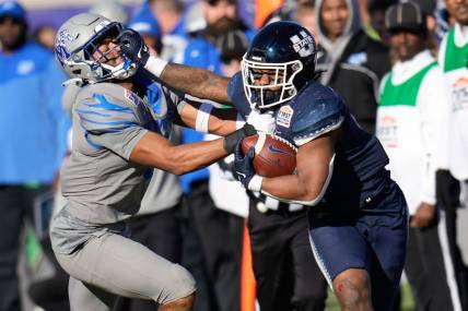 Dec 27, 2022; Dallas, Texas, USA; Utah State Aggies running back Calvin Tyler Jr. (4) breaks a tackle against Memphis Tigers linebacker Geoffrey Cantin-Arku (9) during the first half of the 2022 First Responder Bowl at Gerald J. Ford Stadium. Mandatory Credit: Chris Jones-USA TODAY Sports