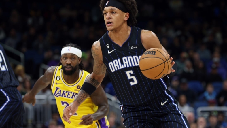 Dec 27, 2022; Orlando, Florida, USA; Orlando Magic forward Paolo Banchero (5) drives to the basket against the Los Angeles Lakers during the first quarter at Amway Center. Mandatory Credit: Kim Klement-USA TODAY Sports