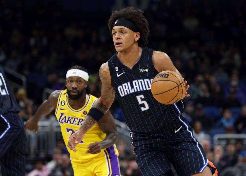 Dec 27, 2022; Orlando, Florida, USA; Orlando Magic forward Paolo Banchero (5) drives to the basket against the Los Angeles Lakers during the first quarter at Amway Center. Mandatory Credit: Kim Klement-USA TODAY Sports
