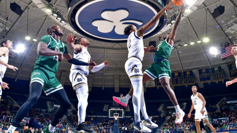 Dec 27, 2022; South Bend, Indiana, USA; Notre Dame Fighting Irish forward Ven-Allen Lubin (2) blocks the shot attempt by Jacksonville Dolphins guard Jordan Davis (11) in the first half at the Purcell Pavilion. Mandatory Credit: Matt Cashore-USA TODAY Sports