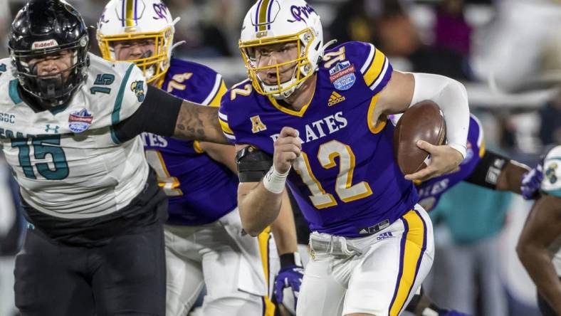 Dec 27, 2022; Birmingham, Alabama, USA; East Carolina Pirates quarterback Holton Ahlers (12) runs the ball against the Coastal Carolina Chanticleers in the 2022 Birmingham Bowl at Protective Stadium. Mandatory Credit: Vasha Hunt-USA TODAY Sports