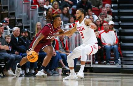 Dec 27, 2022; Lubbock, Texas, USA; South Carolina State Bulldogs forward Davion Everett (55) dribbles the ball against Texas Tech Red Raiders forward Kevin Obanor (0) in the first half at United Supermarkets Arena. Mandatory Credit: Michael C. Johnson-USA TODAY Sports