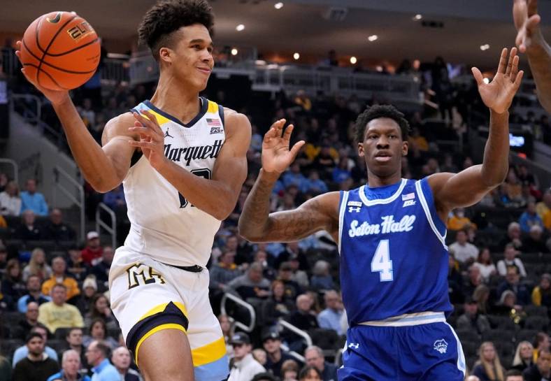 Dec 27, 2022; Milwaukee, Wisconsin, USA; Marquette forward Oso Ighodaro (13) finds an open man as Seton Hall forward Tyrese Samuel (4) defends during the first half at Fiserv Forum. Mandatory Credit: Mark Hoffman-USA TODAY Sports