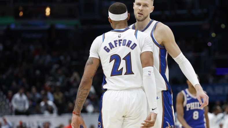 Dec 27, 2022; Washington, District of Columbia, USA; Washington Wizards center Kristaps Porzingis (6) celebrates with Wizards center Daniel Gafford (21) in the final seconds against the Philadelphia 76ers in the fourth quarter at Capital One Arena. Mandatory Credit: Geoff Burke-USA TODAY Sports