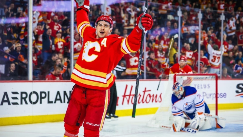 Dec 27, 2022; Calgary, Alberta, CAN; Calgary Flames center Mikael Backlund (11) celebrates his goal against Edmonton Oilers goaltender Stuart Skinner (74) during the second period at Scotiabank Saddledome. Mandatory Credit: Sergei Belski-USA TODAY Sports