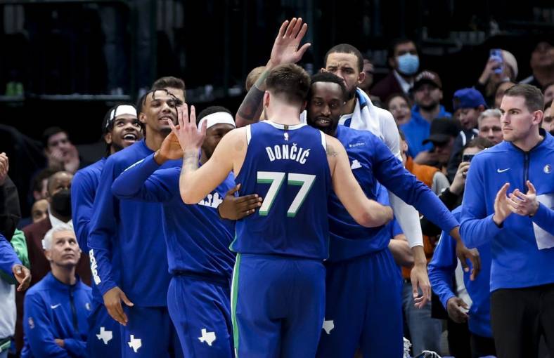 Dec 27, 2022; Dallas, Texas, USA;  Dallas Mavericks guard Luka Doncic (77) celebrates with teammates after leaving the game in overtime against the New York Knicks at American Airlines Center. Mandatory Credit: Kevin Jairaj-USA TODAY Sports