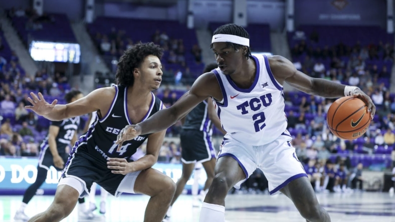 Dec 28, 2022; Fort Worth, Texas, USA;  TCU Horned Frogs forward Emanuel Miller (2) controls the ball as Central Arkansas Bears guard Collin Cooper (14) defends during the first half at Ed and Rae Schollmaier Arena. Mandatory Credit: Kevin Jairaj-USA TODAY Sports