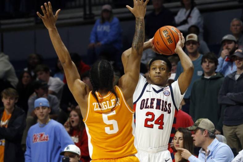 Dec 28, 2022; Oxford, Mississippi, USA; Mississippi Rebels guard Daeshun Ruffin (24) passes the ball against Tennessee Volunteers guard Zakai Zeigler (5) during the first half at The Sandy and John Black Pavilion at Ole Miss. Mandatory Credit: Petre Thomas-USA TODAY Sports