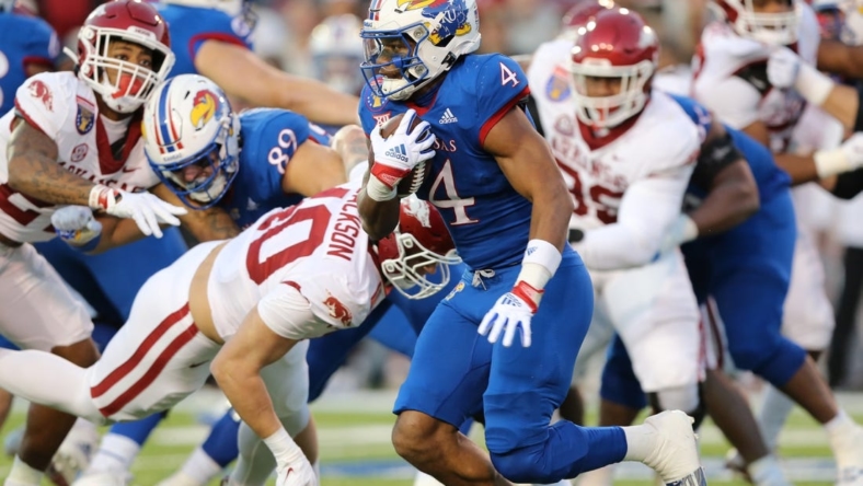 Dec 28, 2022; Memphis, TN, USA; Kansas Jayhawks running back Devin Neal (4) rushes against the Arkansas Razorbacks in the first quarter in the 2022 Liberty Bowl at Liberty Bowl Memorial Stadium. Mandatory Credit: Nelson Chenault-USA TODAY Sports