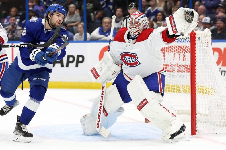 Dec 28, 2022; Tampa, Florida, USA; Montreal Canadiens goaltender Jake Allen (34) makes a save against the Tampa Bay Lightning during the first period at Amalie Arena. Mandatory Credit: Kim Klement-USA TODAY Sports