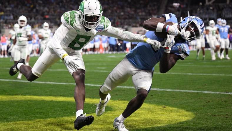 Dec 28, 2022; San Diego, CA, USA; North Carolina Tar Heels wide receiver Andre Greene Jr. (1) catches a touchdown pass while defended by Oregon Ducks defensive back Dontae Manning (8) during the first quarter of the 2022 Holiday Bowl at Petco Park. Mandatory Credit: Orlando Ramirez-USA TODAY Sports