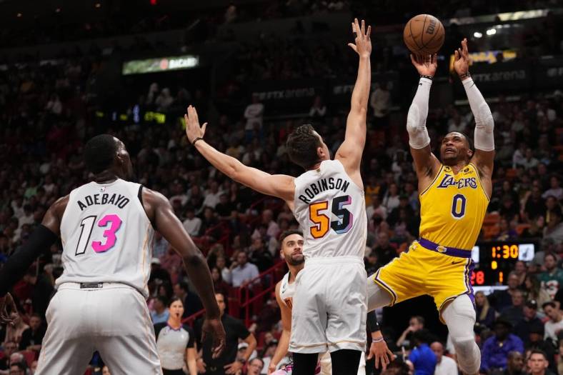 Dec 28, 2022; Miami, Florida, USA; Los Angeles Lakers guard Russell Westbrook (0) shoots around Miami Heat forward Duncan Robinson (55) during the first half at FTX Arena. Mandatory Credit: Jasen Vinlove-USA TODAY Sports