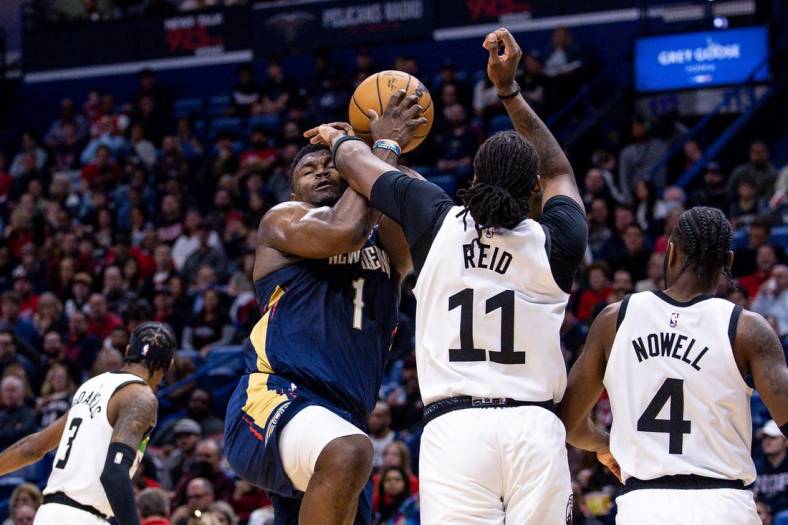 Dec 28, 2022; New Orleans, Louisiana, USA; Minnesota Timberwolves center Naz Reid (11) fouls New Orleans Pelicans forward Zion Williamson (1) as he goes to the basket during the first half at Smoothie King Center. Mandatory Credit: Stephen Lew-USA TODAY Sports