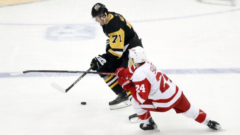 Dec 28, 2022; Pittsburgh, Pennsylvania, USA;  Pittsburgh Penguins center Evgeni Malkin (71) skates with the puck as Detroit Red Wings center Pius Suter (24) defends  during the second period at PPG Paints Arena. Mandatory Credit: Charles LeClaire-USA TODAY Sports