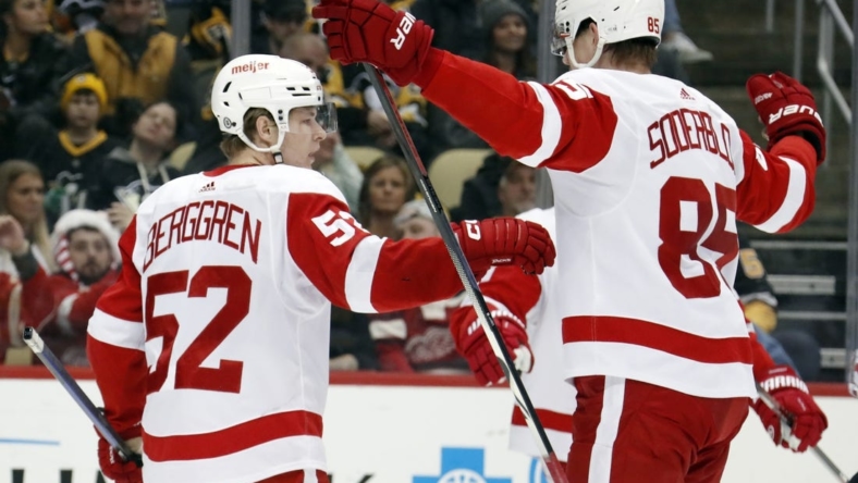 Dec 28, 2022; Pittsburgh, Pennsylvania, USA;  Detroit Red Wings left wing Jonatan Berggren (52) reacts with left wing Elmer Soderblom (85) after Berggren scored a goal against the Pittsburgh Penguins during the third period at PPG Paints Arena. Detroit won 5-4 in overtime. Mandatory Credit: Charles LeClaire-USA TODAY Sports