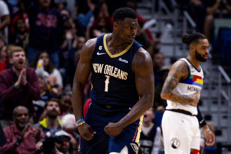 Dec 28, 2022; New Orleans, Louisiana, USA; New Orleans Pelicans forward Zion Williamson (1) reacts to making a basket against Minnesota Timberwolves guard D'Angelo Russell (0) during the second half at Smoothie King Center. Mandatory Credit: Stephen Lew-USA TODAY Sports
