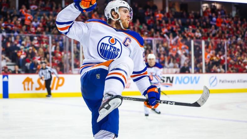 Dec 27, 2022; Calgary, Alberta, CAN; Edmonton Oilers center Connor McDavid (97) celebrates his goal against the Calgary Flames during the third period at Scotiabank Saddledome. Mandatory Credit: Sergei Belski-USA TODAY Sports