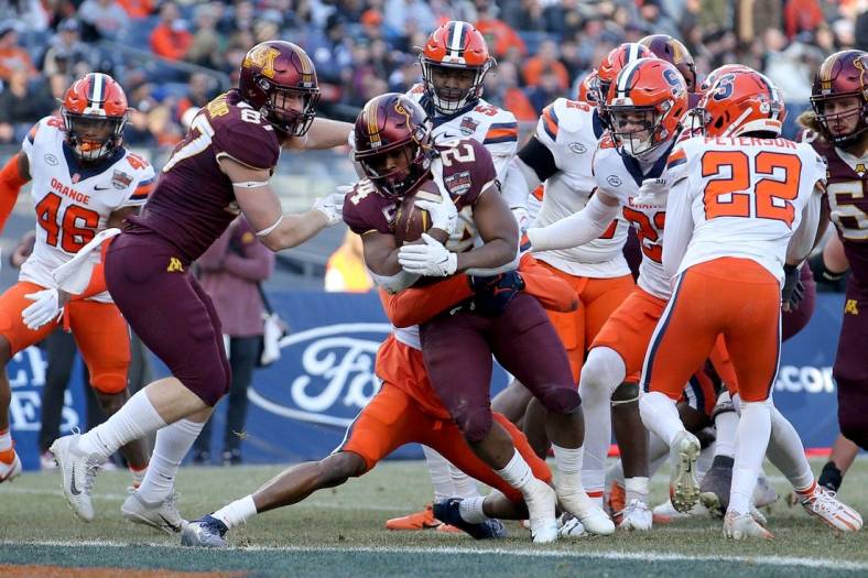 Dec 29, 2022; Bronx, NY, USA; Minnesota Golden Gophers running back Mohamed Ibrahim (24) runs for a touchdown against the Syracuse Orange during the second quarter of the 2022 Pinstripe Bowl at Yankee Stadium. Mandatory Credit: Brad Penner-USA TODAY Sports