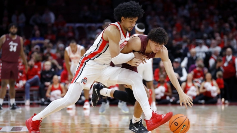 Dec 29, 2022; Columbus, Ohio, USA; Alabama A&M Bulldogs guard Eric Lee (right) fights for the loose ball with Ohio State Buckeyes forward Justice Sueing (14) during the first half at Value City Arena. Mandatory Credit: Joseph Maiorana-USA TODAY Sports