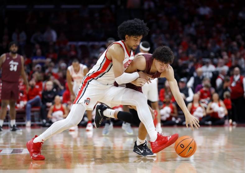 Dec 29, 2022; Columbus, Ohio, USA; Alabama A&M Bulldogs guard Eric Lee (right) fights for the loose ball with Ohio State Buckeyes forward Justice Sueing (14) during the first half at Value City Arena. Mandatory Credit: Joseph Maiorana-USA TODAY Sports