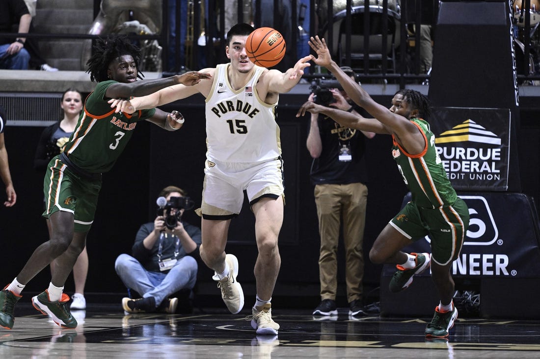 Dec 29, 2022; West Lafayette, Indiana, USA; Purdue Boilermakers center Zach Edey (15) reaches for a rebound between Florida A&M Rattlers forward Peyton Williams (3) and Florida A&M Rattlers guard Jordan Tillmon (23) during the first half at Mackey Arena. Mandatory Credit: Marc Lebryk-USA TODAY Sports