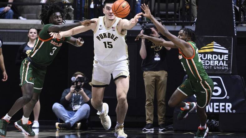 Dec 29, 2022; West Lafayette, Indiana, USA; Purdue Boilermakers center Zach Edey (15) reaches for a rebound between Florida A&M Rattlers forward Peyton Williams (3) and Florida A&M Rattlers guard Jordan Tillmon (23) during the first half at Mackey Arena. Mandatory Credit: Marc Lebryk-USA TODAY Sports