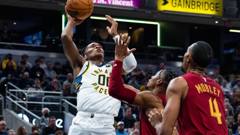 Dec 29, 2022; Indianapolis, Indiana, USA; Indiana Pacers guard Bennedict Mathurin (00) shoots the ball while Cleveland Cavaliers forward Isaac Okoro (35) defends at Gainbridge Fieldhouse. Mandatory Credit: Trevor Ruszkowski-USA TODAY Sports