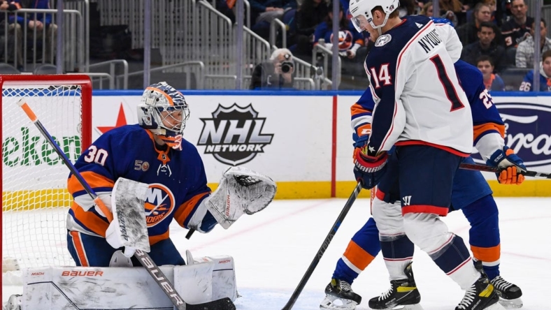 Dec 29, 2022; Elmont, New York, USA; New York Islanders goaltender Ilya Sorokin (30) makes a save against as Columbus Blue Jackets left wing Gustav Nyquist (14) looks for a rebound during the first period at UBS Arena. Mandatory Credit: Dennis Schneidler-USA TODAY Sports