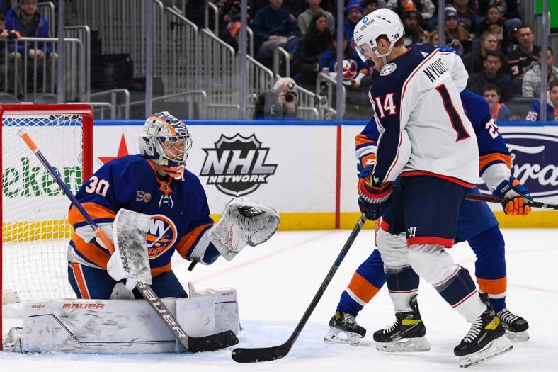 Dec 29, 2022; Elmont, New York, USA; New York Islanders goaltender Ilya Sorokin (30) makes a save against as Columbus Blue Jackets left wing Gustav Nyquist (14) looks for a rebound during the first period at UBS Arena. Mandatory Credit: Dennis Schneidler-USA TODAY Sports