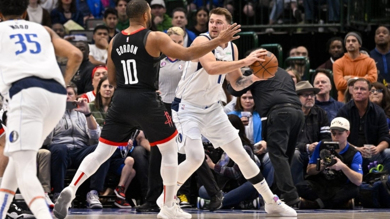 Dec 29, 2022; Dallas, Texas, USA; Dallas Mavericks guard Luka Doncic (77) looks to pass around Houston Rockets guard Eric Gordon (10) during the first quarter at the American Airlines Center. Mandatory Credit: Jerome Miron-USA TODAY Sports