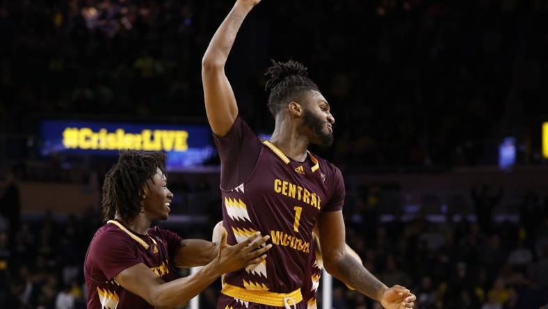 Dec 29, 2022; Ann Arbor, Michigan, USA;  Central Michigan Chippewas forward Ola Ajiboye (11) and guard Reggie Bass (1) celebrate after defeating the Michigan Wolverines at Crisler Center. Mandatory Credit: Rick Osentoski-USA TODAY Sports