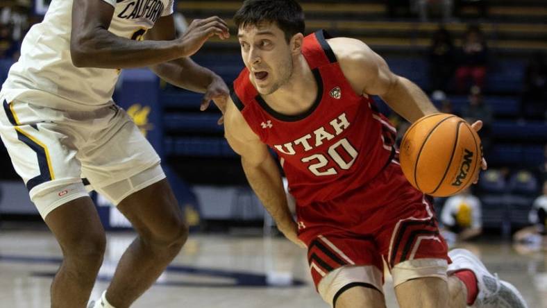 Dec 29, 2022; Berkeley, California, USA; Utah Utes guard Lazar Stefanovic (20) drives around California Golden Bears guard Marsalis Roberson (0) during the first half at Haas Pavilion. Mandatory Credit: D. Ross Cameron-USA TODAY Sports