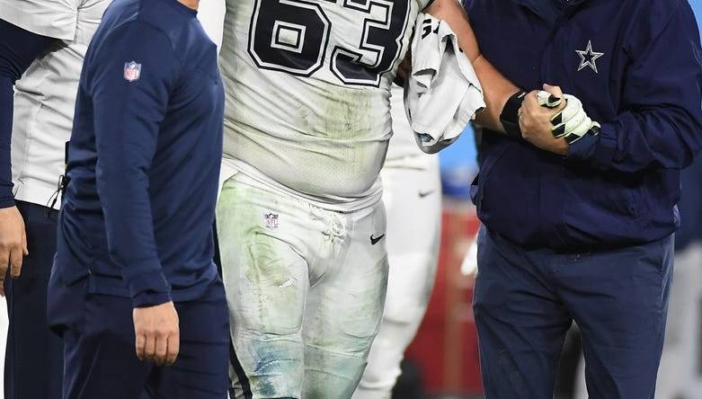 Dec 29, 2022; Nashville, Tennessee, USA; Dallas Cowboys center Tyler Biadasz (63) is helped off the field after an injury during the second half against the Tennessee Titans at Nissan Stadium. Mandatory Credit: Christopher Hanewinckel-USA TODAY Sports