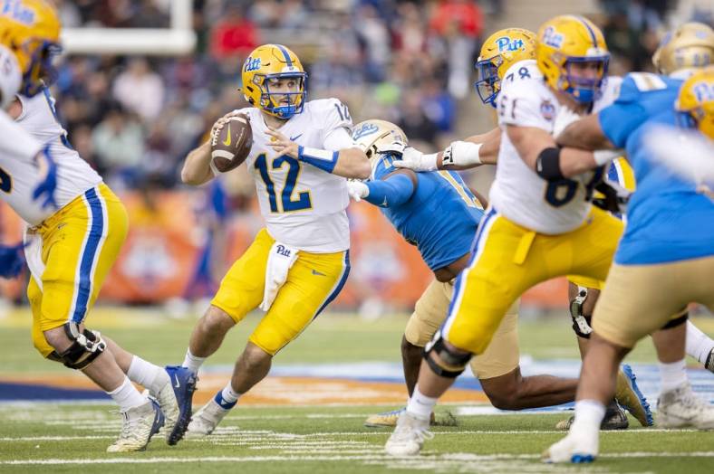 Dec 30, 2022; El Paso, Texas, USA; Pittsburgh Panthers quarterback Nick Patti (12) throws the ball against the UCLA Bruins defense in the first half of the 2022 Sun Bowl at Sun Bowl. Mandatory Credit: Ivan Pierre Aguirre-USA TODAY Sports