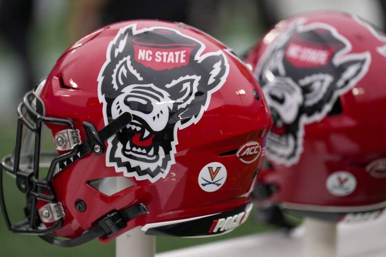 Dec 30, 2022; Charlotte, NC, USA; North Carolina State Wolfpack helmets during the first half against the Maryland Terrapins in the 2022 Duke's Mayo Bowl at Bank of America Stadium. Mandatory Credit: Jim Dedmon-USA TODAY Sports