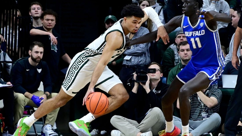 Dec 30, 2022; East Lansing, Michigan, USA; in his first game back from a foot injury Michigan State Spartans forward Malik Hall (25) drives against Buffalo Bulls forward Kuluel Mading (11) in the first half at Jack Breslin Student Events Center. Mandatory Credit: Dale Young-USA TODAY Sports