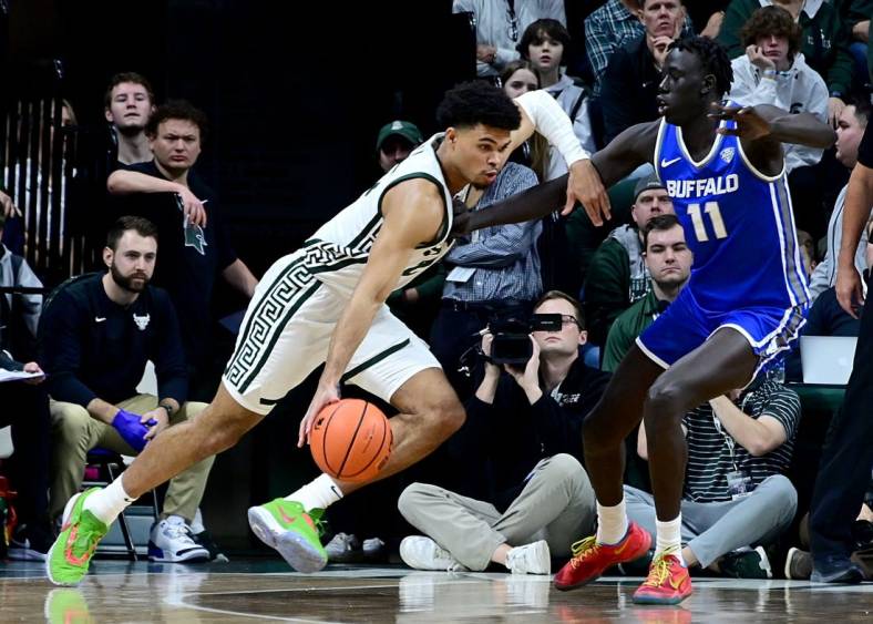 Dec 30, 2022; East Lansing, Michigan, USA; in his first game back from a foot injury Michigan State Spartans forward Malik Hall (25) drives against Buffalo Bulls forward Kuluel Mading (11) in the first half at Jack Breslin Student Events Center. Mandatory Credit: Dale Young-USA TODAY Sports