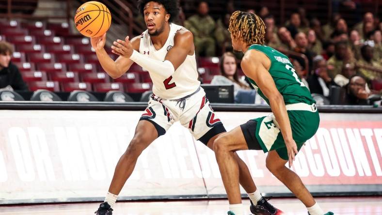 Dec 30, 2022; Columbia, South Carolina, USA; South Carolina Gamecocks guard Chico Carter Jr. (2) passes around Eastern Michigan Eagles guard Noah Farrakhan (2) in the first half at Colonial Life Arena. Mandatory Credit: Jeff Blake-USA TODAY Sports