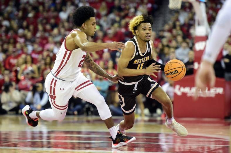 Dec 30, 2022; Madison, Wisconsin, USA; Western Michigan Broncos guard Lamar Norman Jr. (11) dribbles the ball under coverage by Wisconsin Badgers guard Chucky Hepburn (23) during the first half at the Kohl Center. Mandatory Credit: Kayla Wolf-USA TODAY Sports