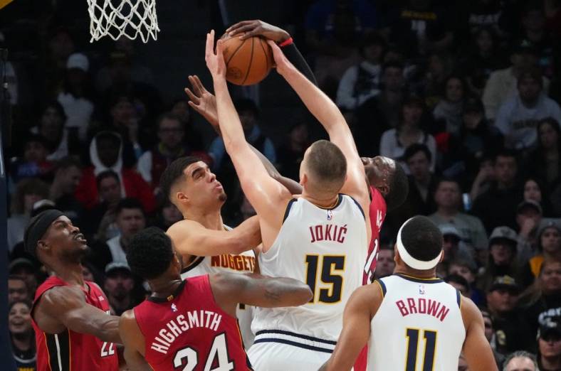 Dec 30, 2022; Denver, Colorado, USA; Miami Heat forward Jimmy Butler (22) and forward Haywood Highsmith (24) and center Bam Adebayo (13) and Denver Nuggets center Nikola Jokic (15) and forward Bruce Brown (11) reach for a rebound in the first quarter at Ball Arena. Mandatory Credit: Ron Chenoy-USA TODAY Sports