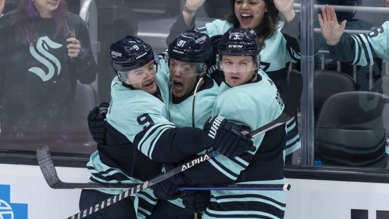 Dec 30, 2022; Seattle, Washington, USA; Seattle Kraken forward Daniel Sprong (91) is congratulated by forward Ryan Donato (9) and defenseman Will Borgen (3) after scoring a goal during the second period against the Edmonton Oilers at Climate Pledge Arena. Mandatory Credit: Stephen Brashear-USA TODAY Sports