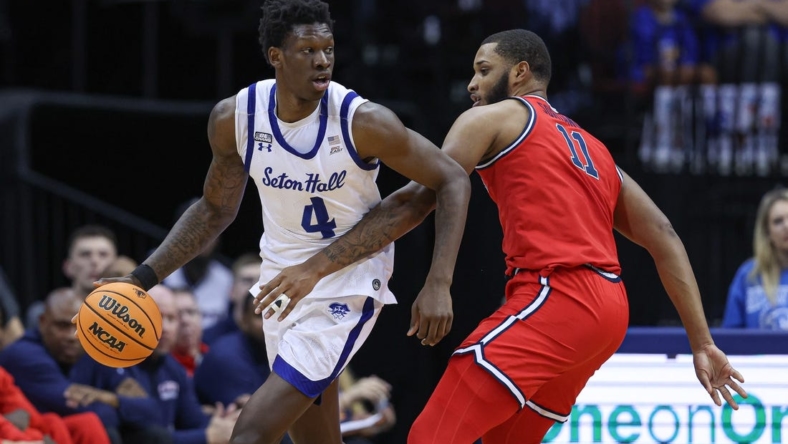 Dec 31, 2022; Newark, New Jersey, USA; Seton Hall Pirates forward Tyrese Samuel (4) dribbles as St. John's Red Storm center Joel Soriano (11) defends during the first half at Prudential Center. Mandatory Credit: Vincent Carchietta-USA TODAY Sports