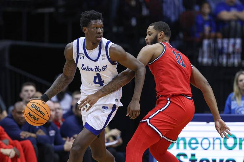 Dec 31, 2022; Newark, New Jersey, USA; Seton Hall Pirates forward Tyrese Samuel (4) dribbles as St. John's Red Storm center Joel Soriano (11) defends during the first half at Prudential Center. Mandatory Credit: Vincent Carchietta-USA TODAY Sports