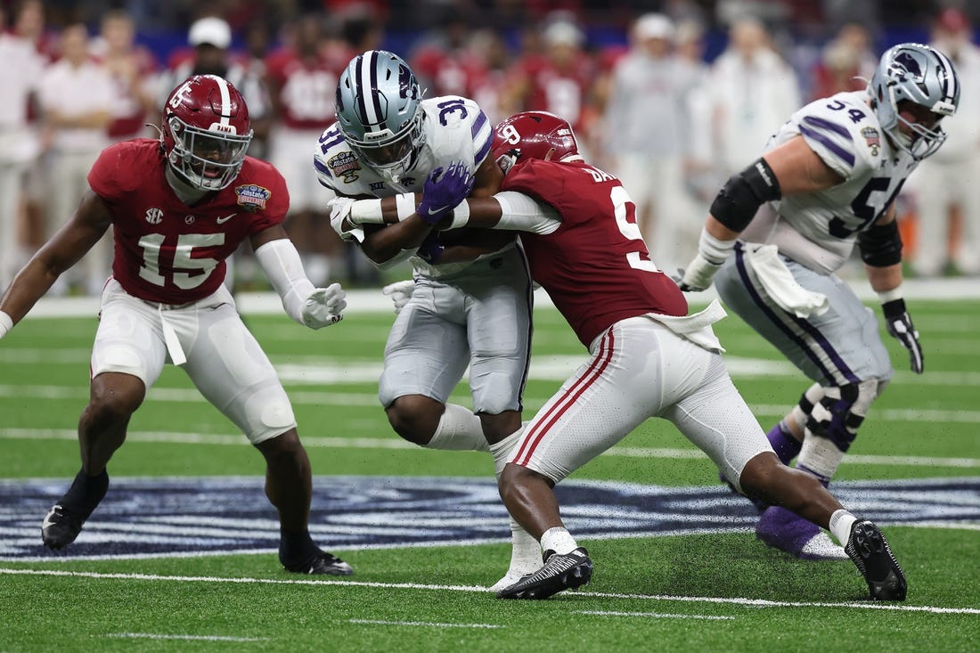 Dec 31, 2022; New Orleans, LA, USA; Kansas State Wildcats running back DJ Giddens (31) runs the ball against Alabama Crimson Tide defensive back Jordan Battle (9) during the first half in the 2022 Sugar Bowl at Caesars Superdome. Mandatory Credit: Stephen Lew-USA TODAY Sports