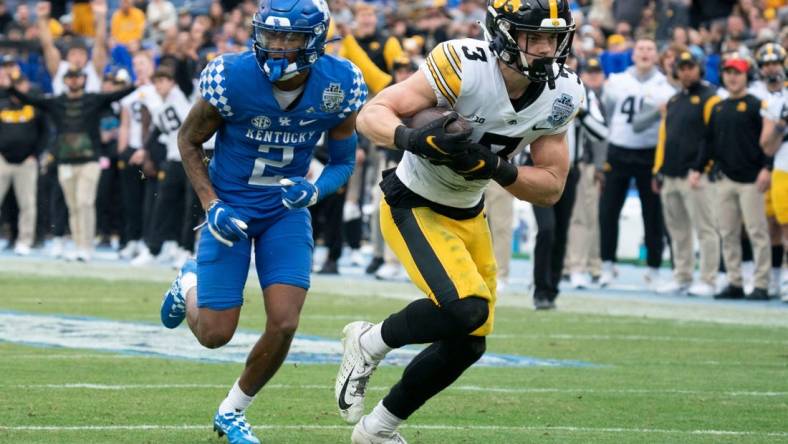 Iowa defensive back Cooper DeJean (3) pulls in an interception for a touchdown over Kentucky wide receiver Barion Brown (2) during the second quarter of the TransPerfect Music City Bowl at Nissan Stadium Saturday, Dec. 31, 2022, in Nashville, Tenn.

Ncaa Football Music City Bowl Iowa At Kentucky