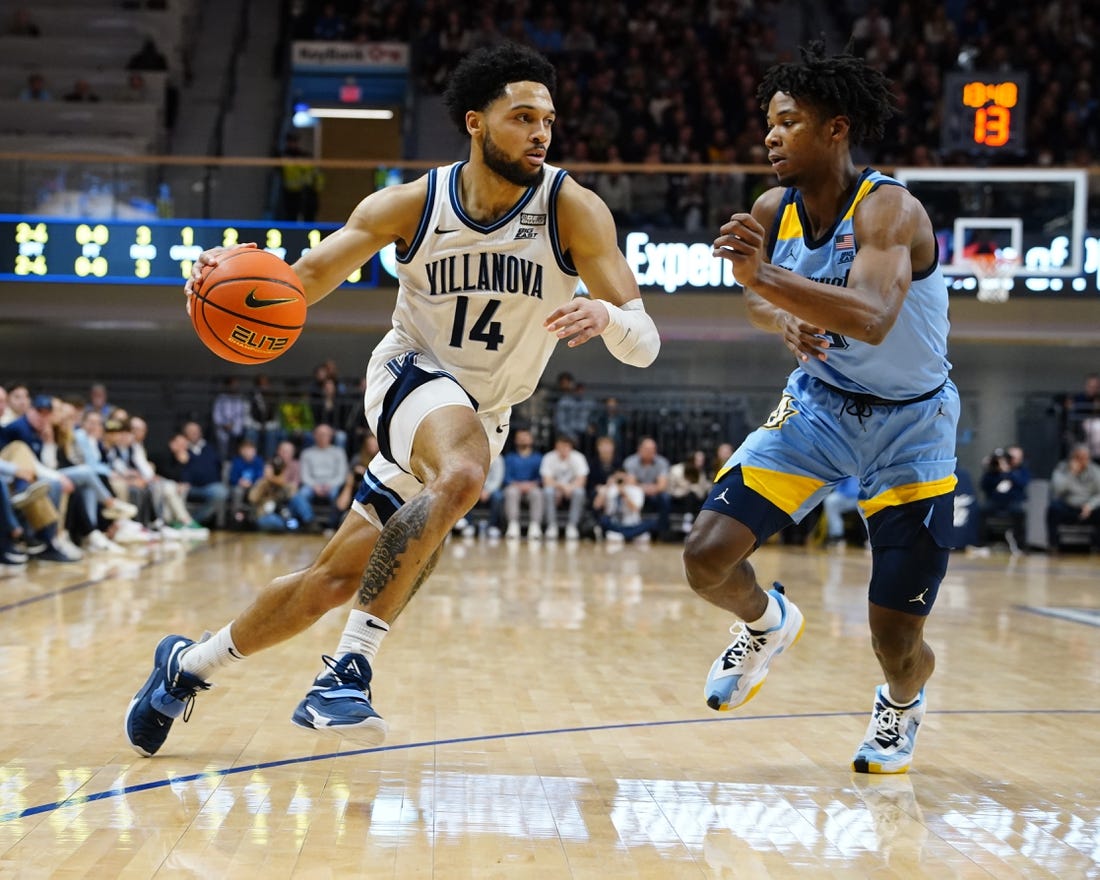 Dec 31, 2022; Villanova, Pennsylvania, USA; Villanova Wildcats guard Caleb Daniels (14) drives the ball against Marquette Golden Eagles  guard Chase Ross (5) during the first half at William B. Finneran Pavilion. Mandatory Credit: Gregory Fisher-USA TODAY Sports