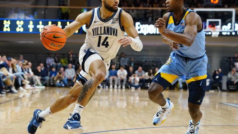 Dec 31, 2022; Villanova, Pennsylvania, USA; Villanova Wildcats guard Caleb Daniels (14) drives the ball against Marquette Golden Eagles  guard Chase Ross (5) during the first half at William B. Finneran Pavilion. Mandatory Credit: Gregory Fisher-USA TODAY Sports