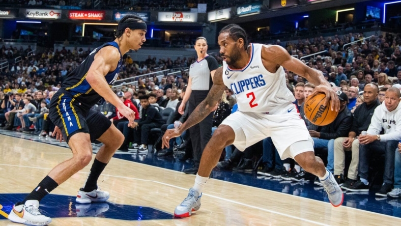 Dec 31, 2022; Indianapolis, Indiana, USA; LA Clippers forward Kawhi Leonard (2) dribbles the ball while Indiana Pacers guard Andrew Nembhard (2) defends in the first quarter at Gainbridge Fieldhouse. Mandatory Credit: Trevor Ruszkowski-USA TODAY Sports